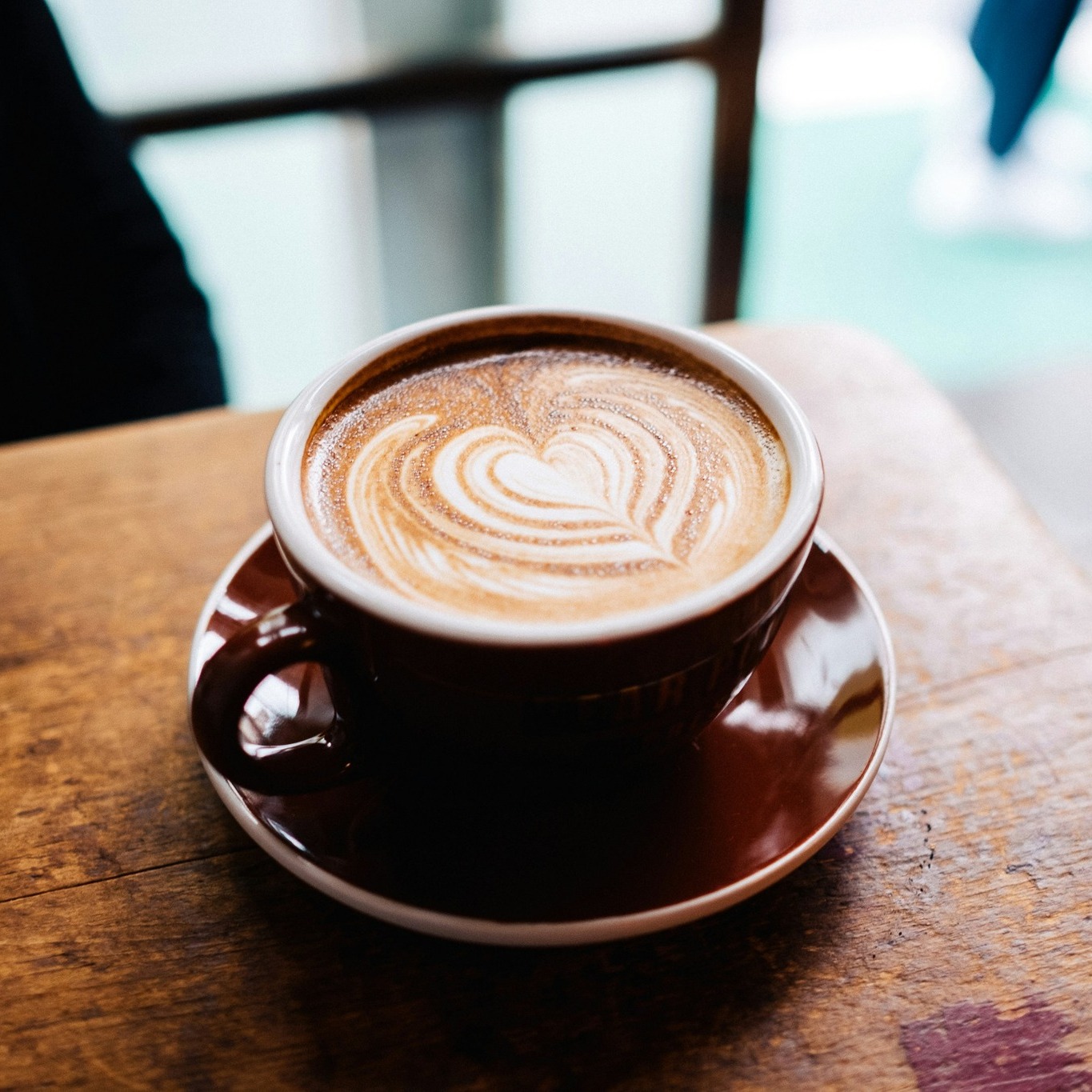 Latte art in a ceramic cup at Yew Coffee